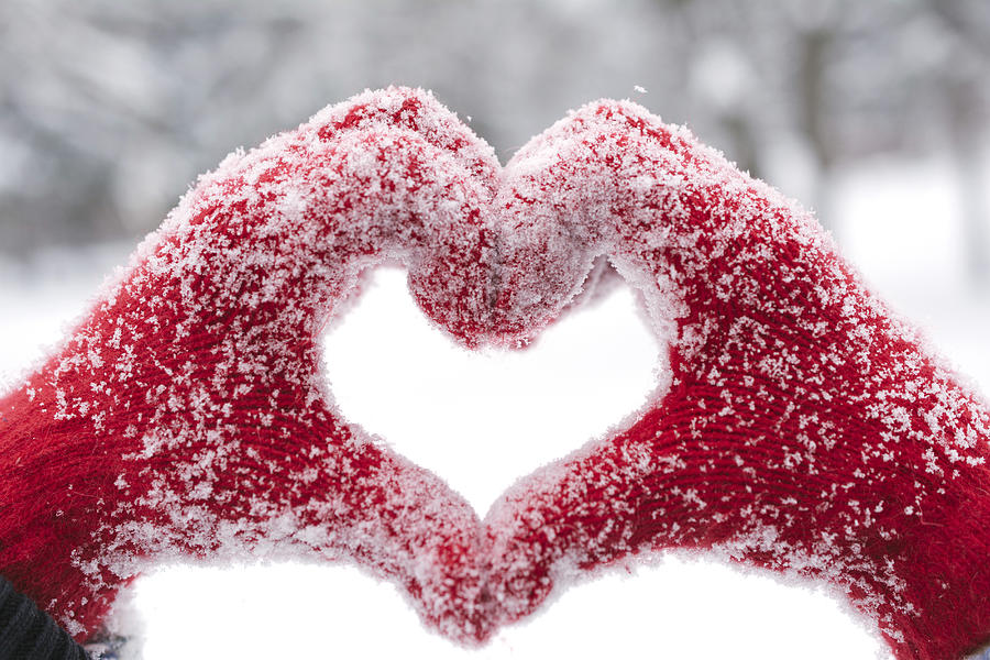 Woman making heart symbol with snowy hands Photograph by Jasper Chamber