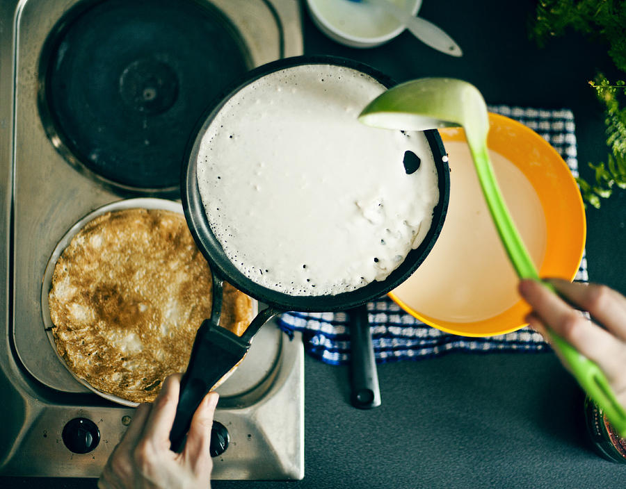 Woman making pancakes in kitchen Photograph by Aliyev Alexei Sergeevich