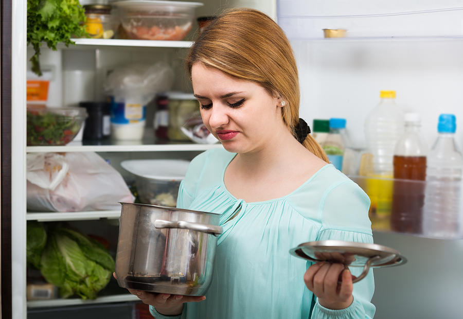 Woman Noticed Foul Smell Of Food From Casserole Photograph by JackF
