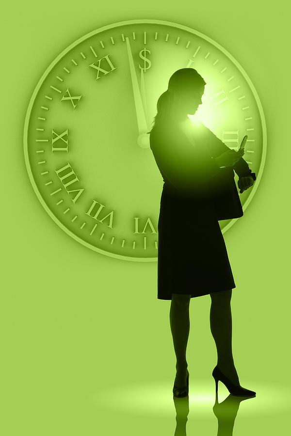 Woman on cellphone by large clock Photograph by Comstock Images