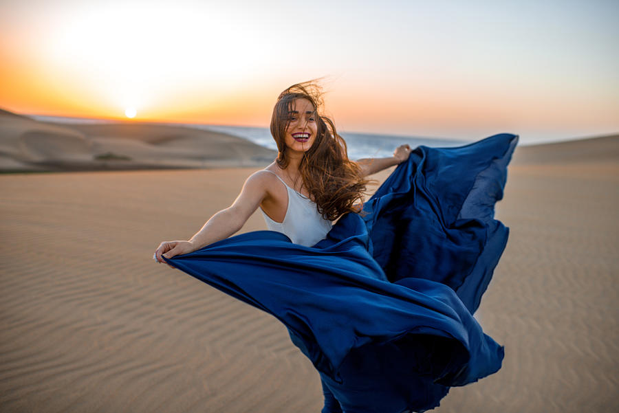 Woman on the sand dunes Photograph by RossHelen