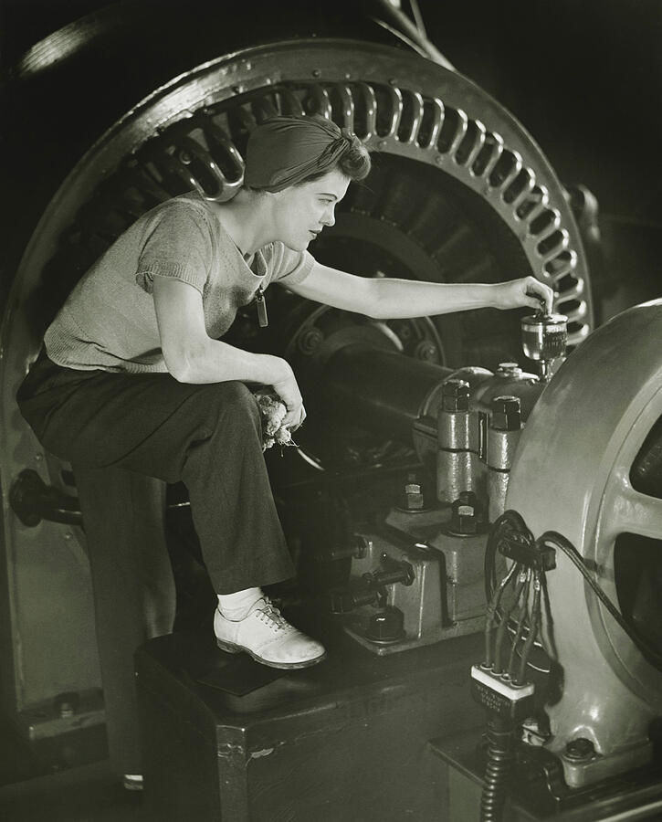 Woman operating machine in factory, (B&W) Photograph by George Marks
