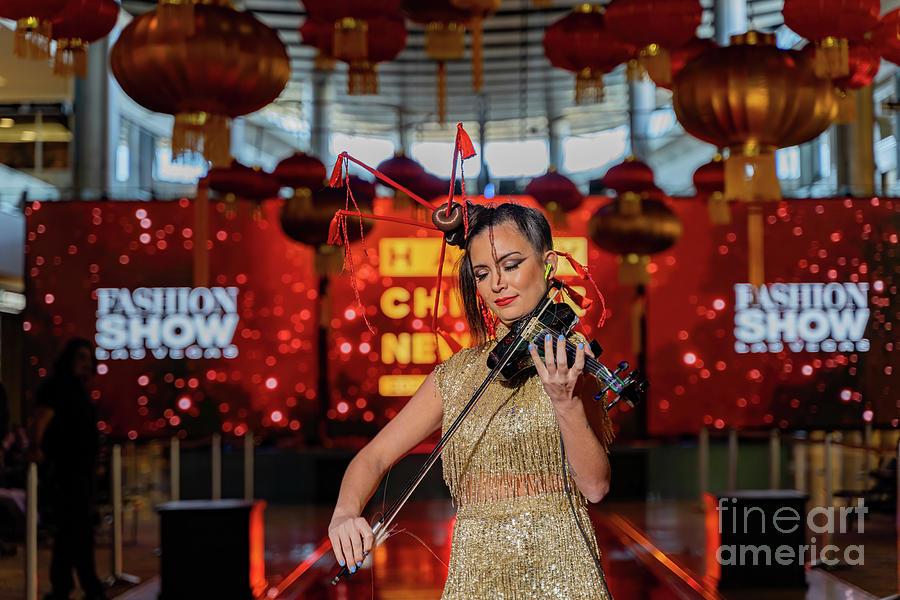 Las Vegas Photograph - Woman performaning violin in the East Meets West Runway Show in  by Chon Kit Leong