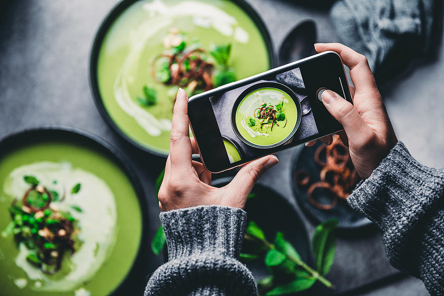 Woman photographing fresh green soup Photograph by Alvarez