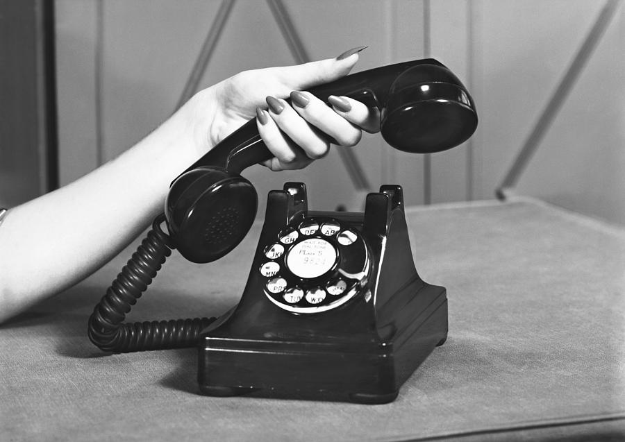 Woman picking up phone, (close up of hand), (B&W) Photograph by George Marks