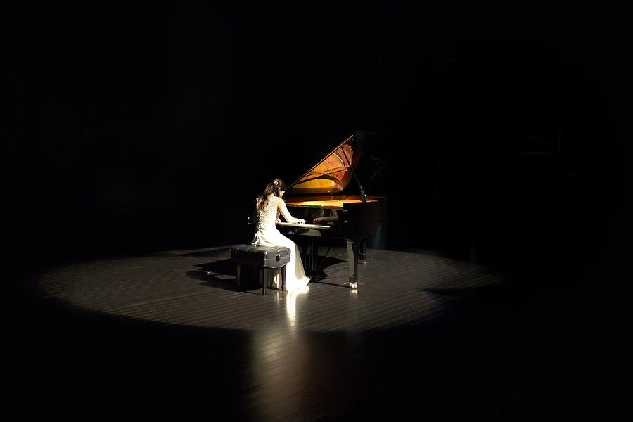 Woman playing the piano Photograph by Tadamasa Taniguchi