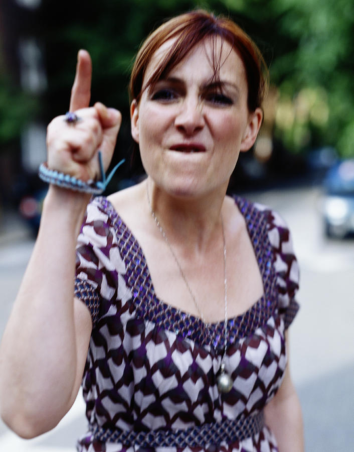 Woman pointing finger aggressively, portrait Photograph by Digital Vision