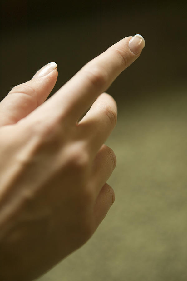 Woman pointing finger, close-up of hand Photograph by Photodisc
