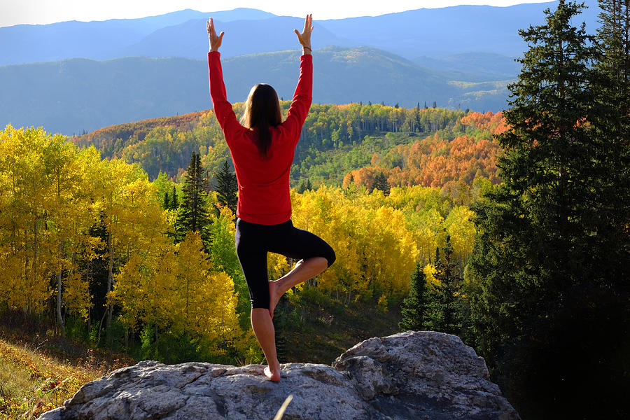 Woman practicing yoga outdoors in fall colors Photograph by David Epperson