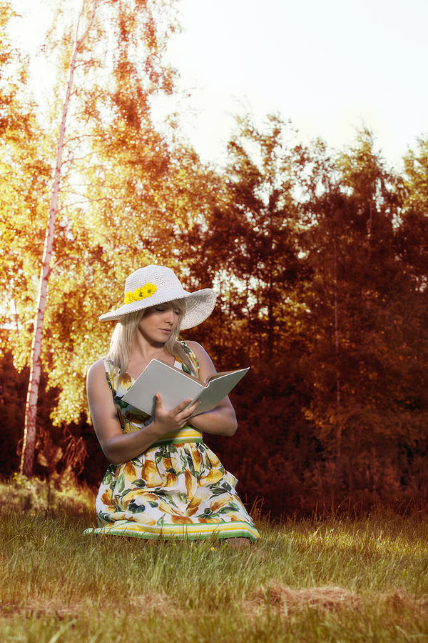 Woman reading a book Photograph by Fotek
