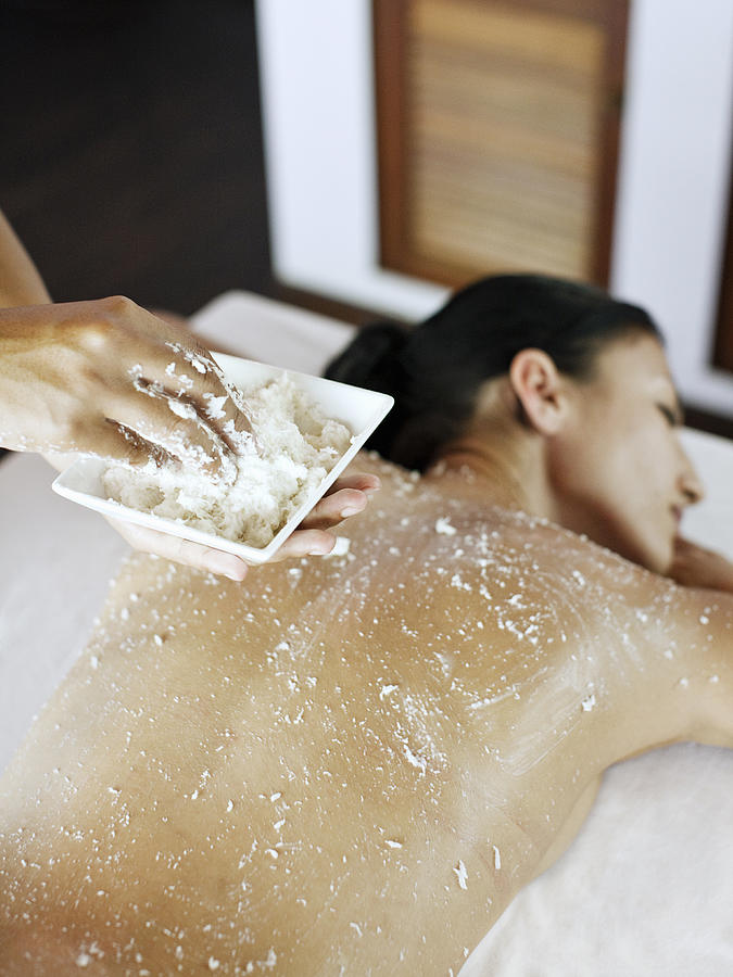 Woman receives body scrub at spa. Photograph by Matthew Wakem Woman receives body scrub at spa. Photograph by Matthew Wakem