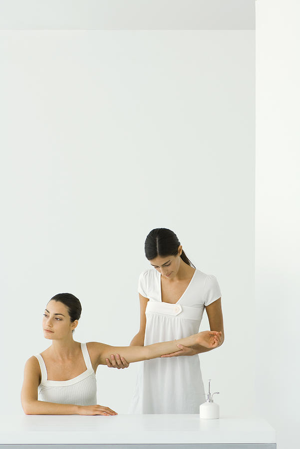 Woman receiving arm massage, looking away Photograph by ZenShui/Milena Boniek