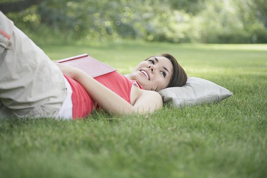 Woman relaxing in grass Photograph by Tammy Hanratty
