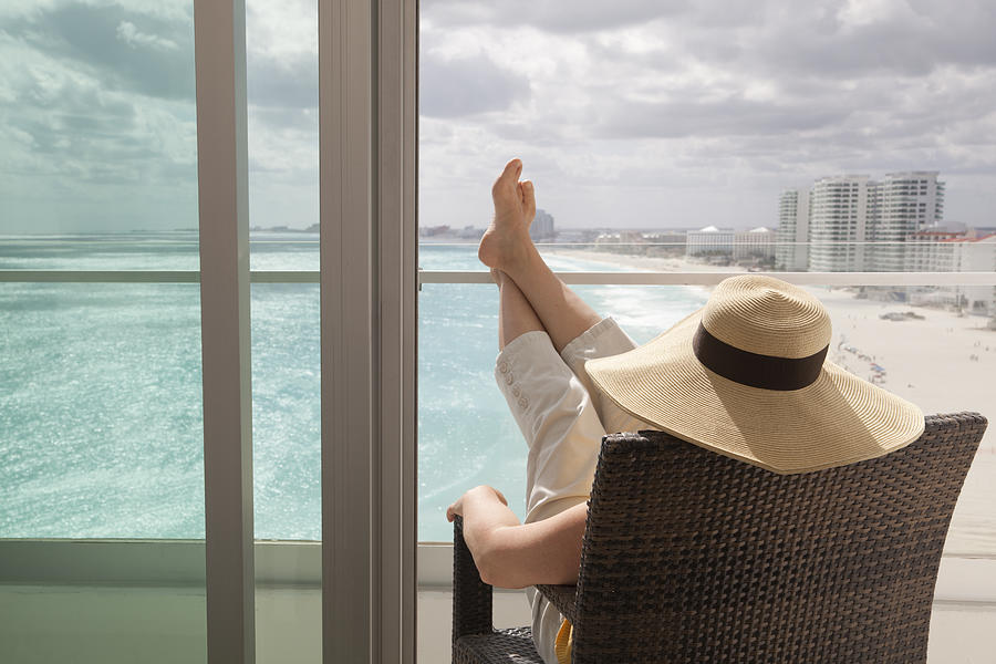 Woman Relaxing in Hotel Balcony of Beach Resort Photograph by YinYang