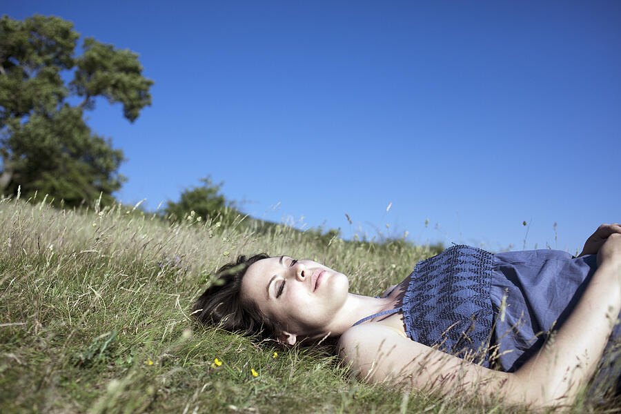 Woman relaxing on hill Photograph by Chev Wilkinson
