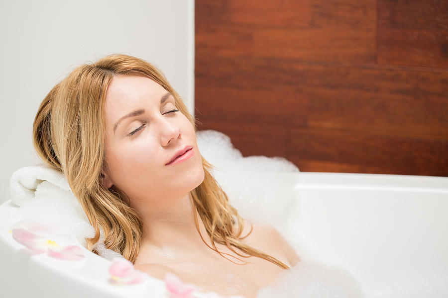 Woman resting during bath Photograph by KatarzynaBialasiewicz