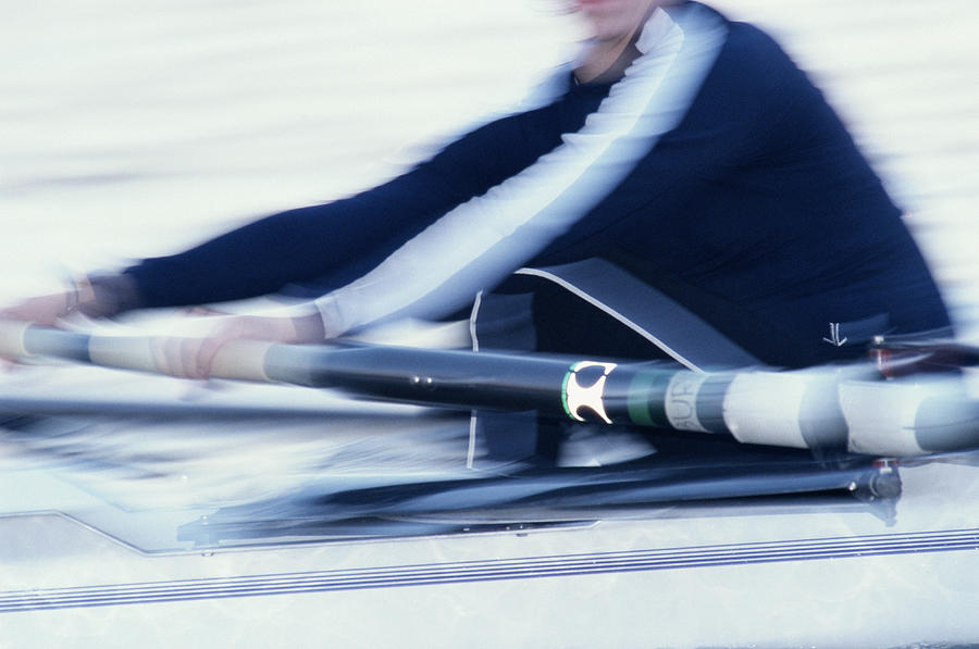 Woman rowing on crew team, mid section (blurred motion) Photograph by Chase Jarvis