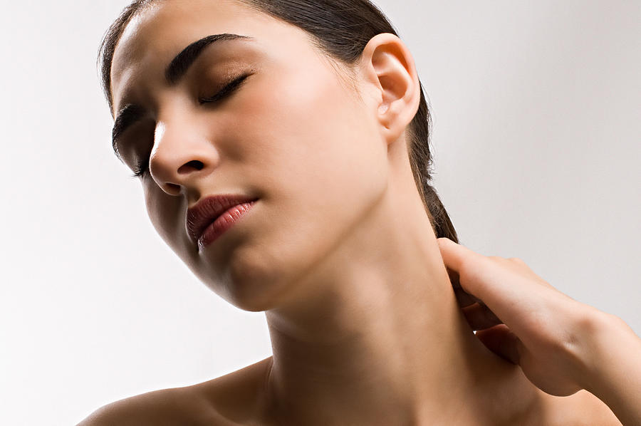 Woman rubbing neck Photograph by Image Source
