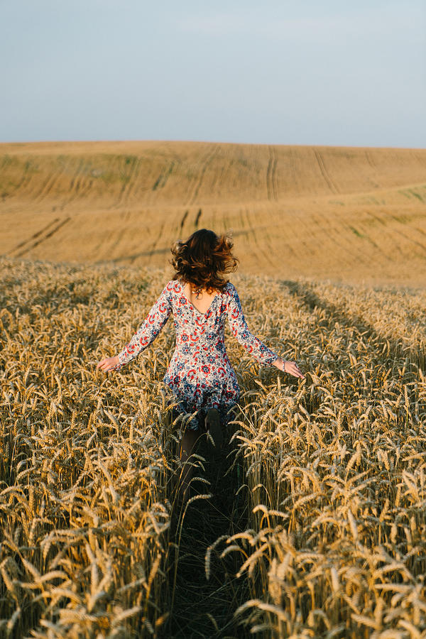 Woman running in the wheat field Photograph by Oleh_Slobodeniuk