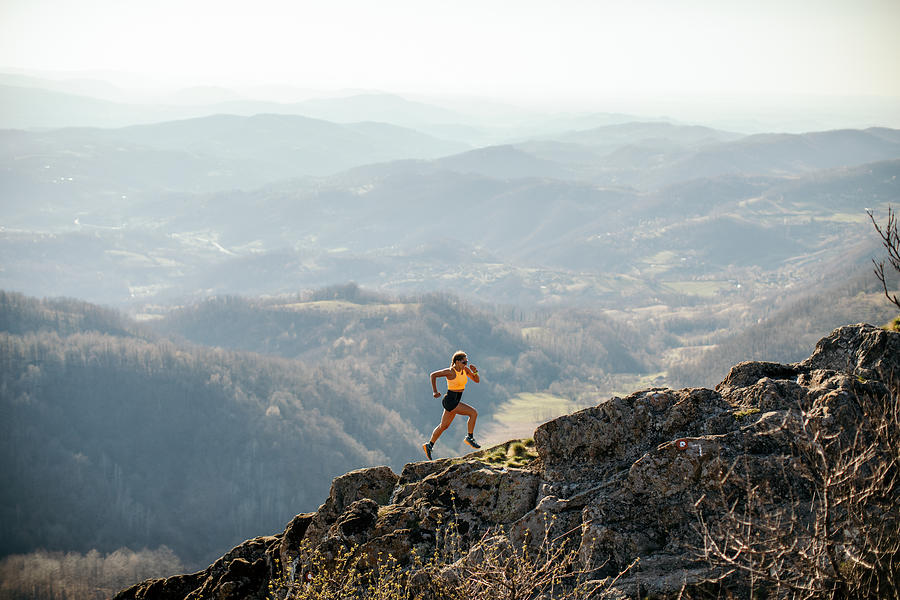 Woman running on mountain Photograph by Miljko