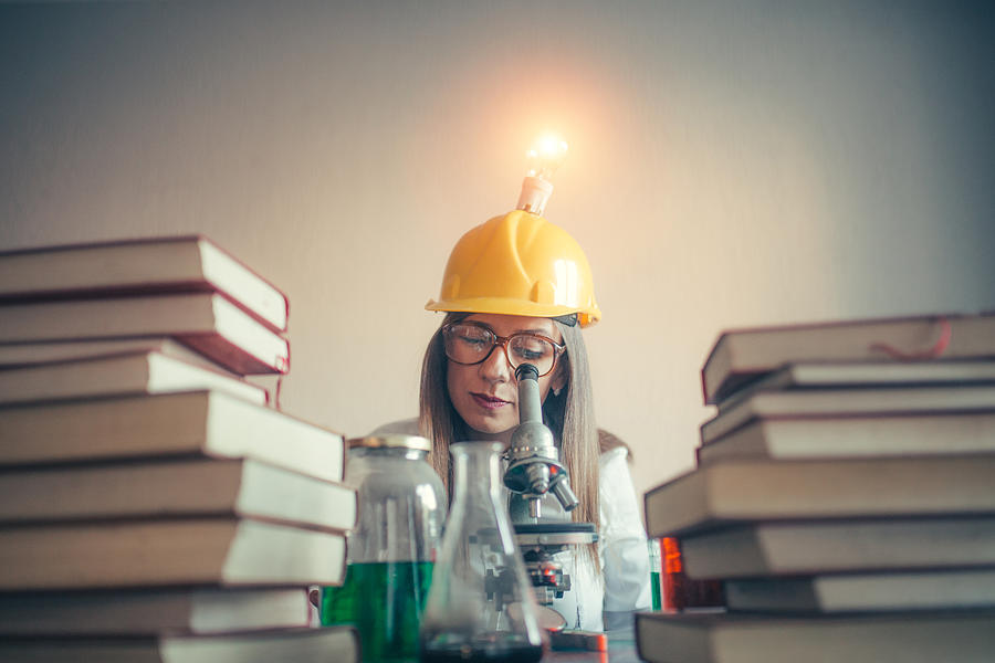 Woman scientist reading Photograph by South_agency