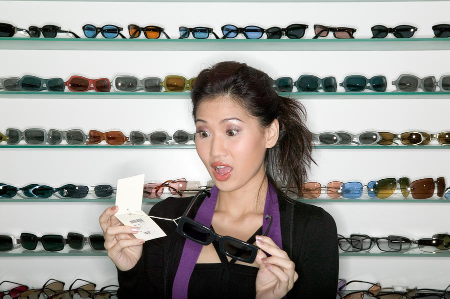 Woman shopping for sunglasses Photograph by Image Source