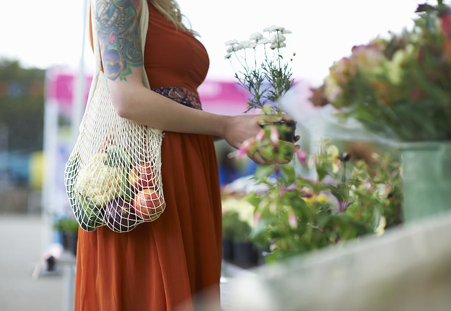 Woman shopping on local market with plastic free reusable bag. Photograph by Dougal Waters