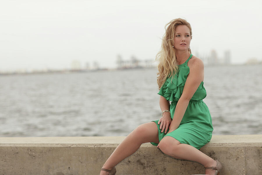 Woman Sitting By The Bay In A Green Dress Photograph
