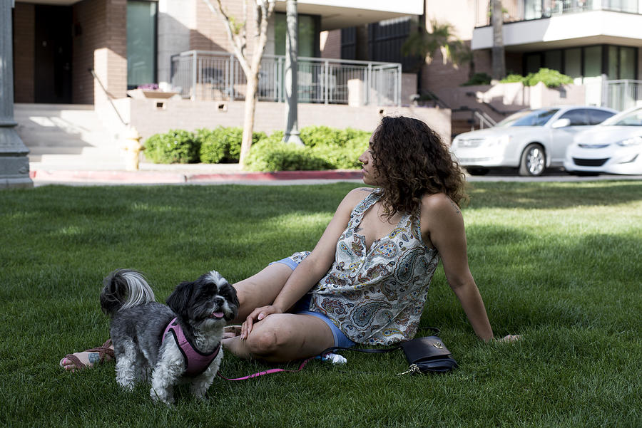 Woman sitting in park with dog Photograph by Scott Zdon