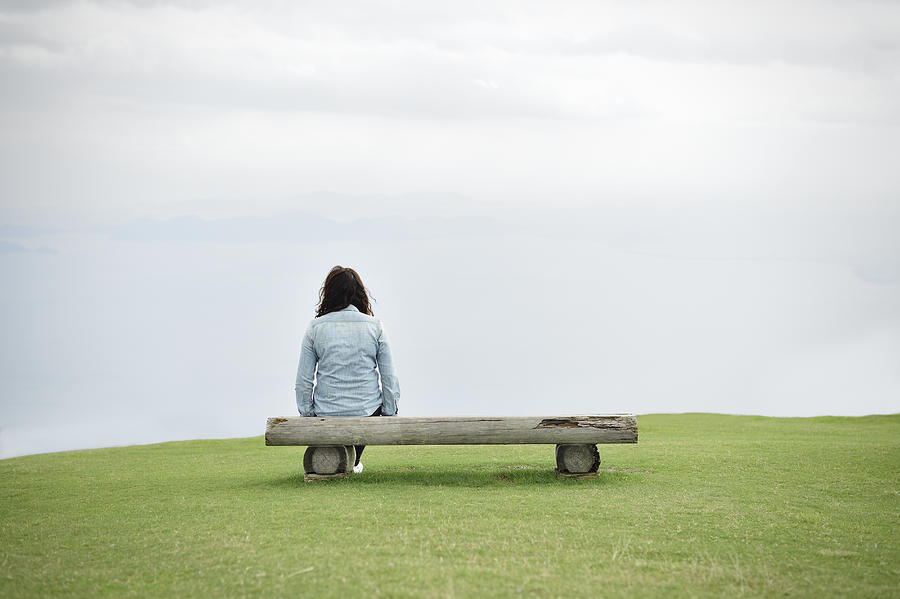 Woman sitting on a bench Photograph by Yagi Studio