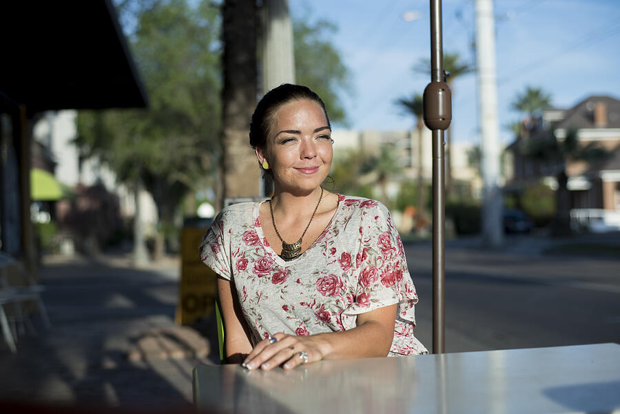 Woman sitting outside at neighborhood cafe Photograph by Scott Zdon