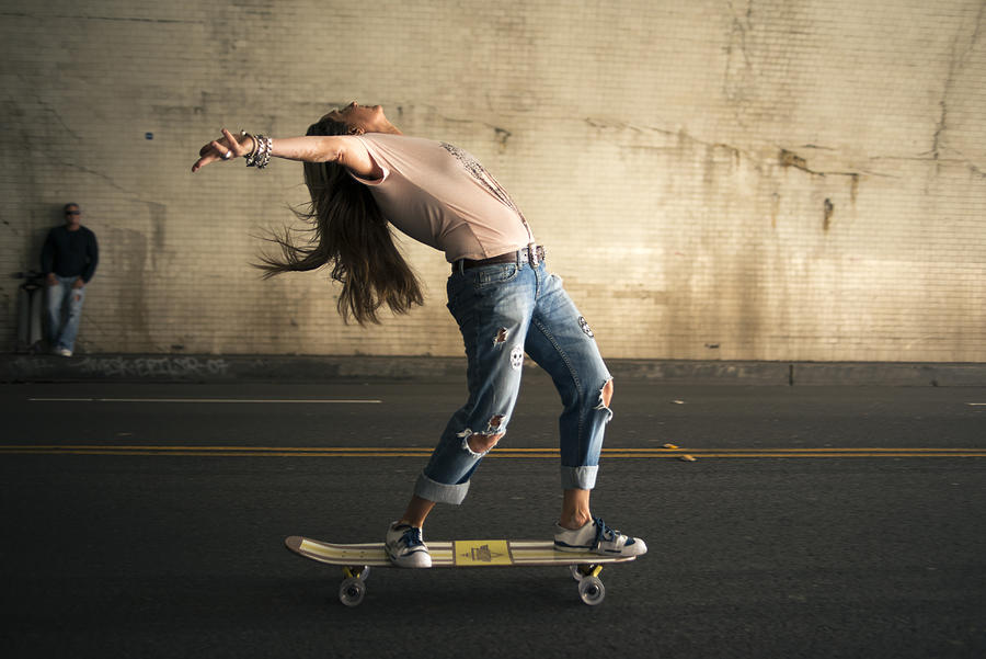 Woman skateboarding in tunnel Photograph by Ian Logan