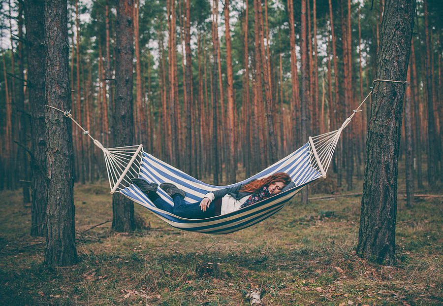 Woman sleeping in a hammock in the wood. Photograph by Guido Mieth