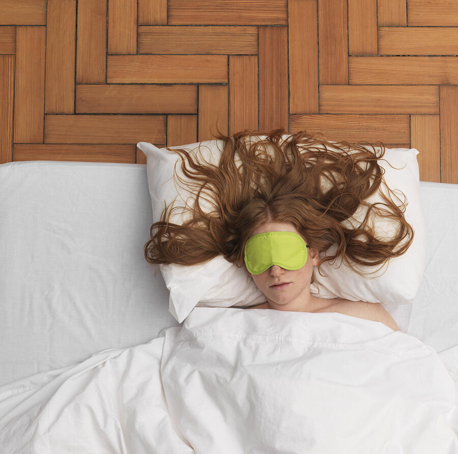 Woman sleeping, wearing eye-mask Photograph by Jlph