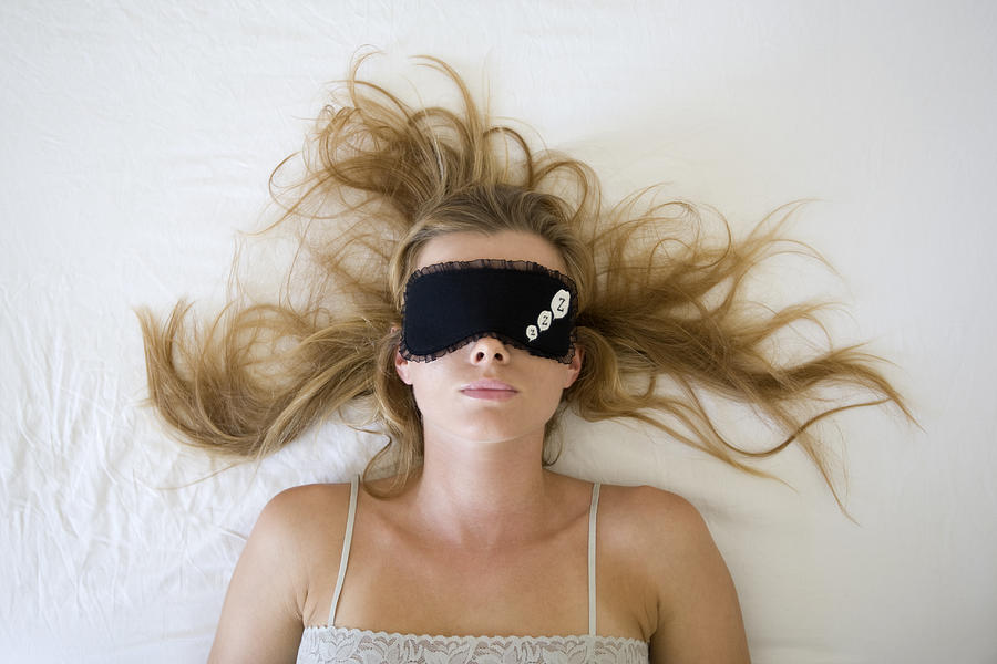 Woman sleeping with eye mask Photograph by B2M Productions