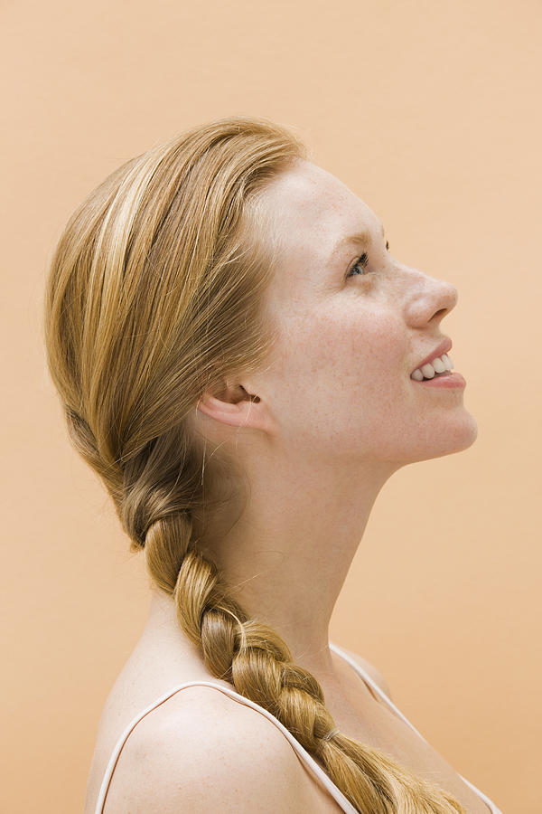 Woman smiling, looking up, side view Photograph by Pando Hall