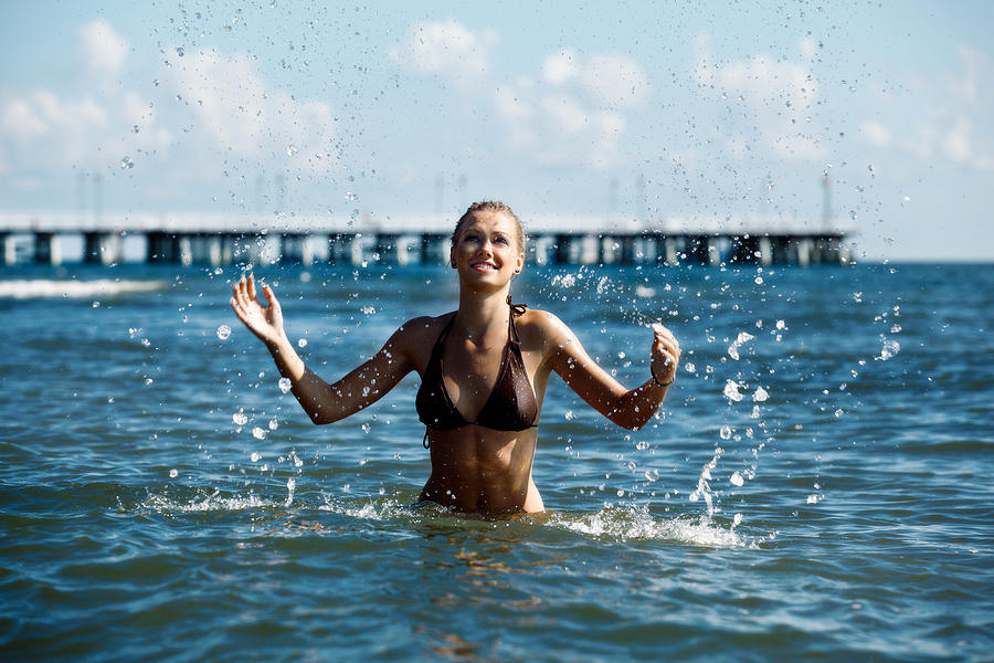 Woman spraying in sea Photograph by Fotek