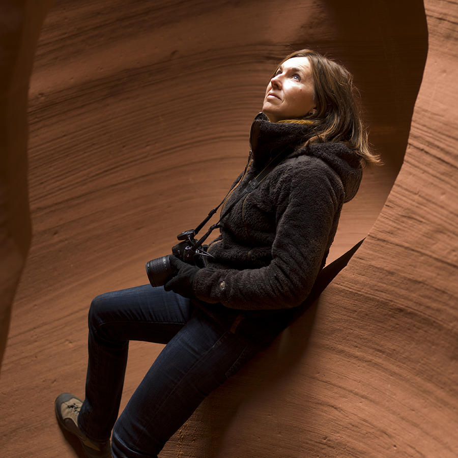 Woman standing in a slot canyon Photograph by Fotosearch