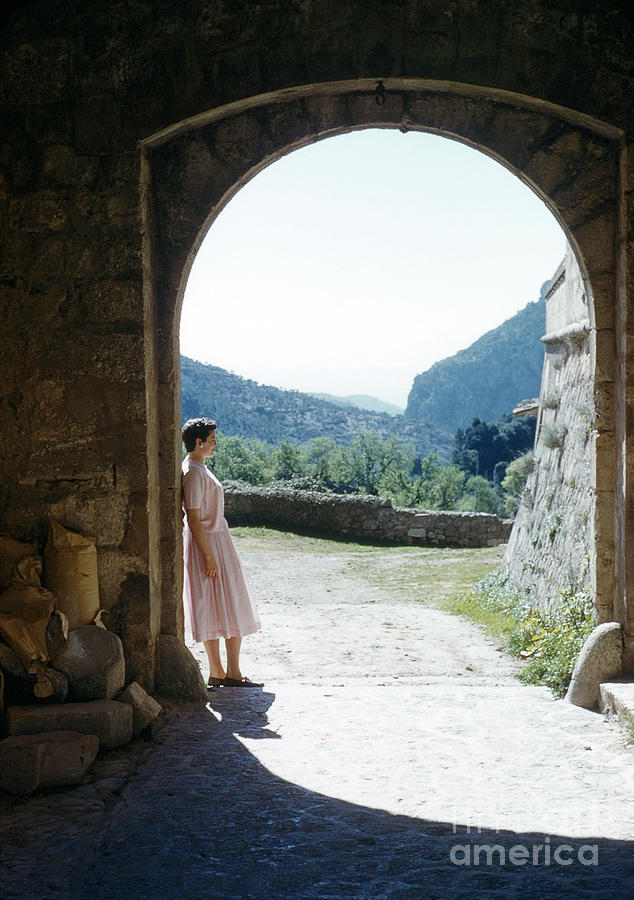 Woman standing in archway in rural France Photograph by Sheila Robinson