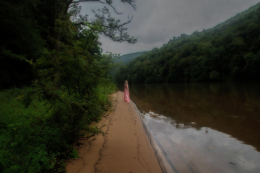 Woman standing on shoreline along a lake Photograph by Dan Friend