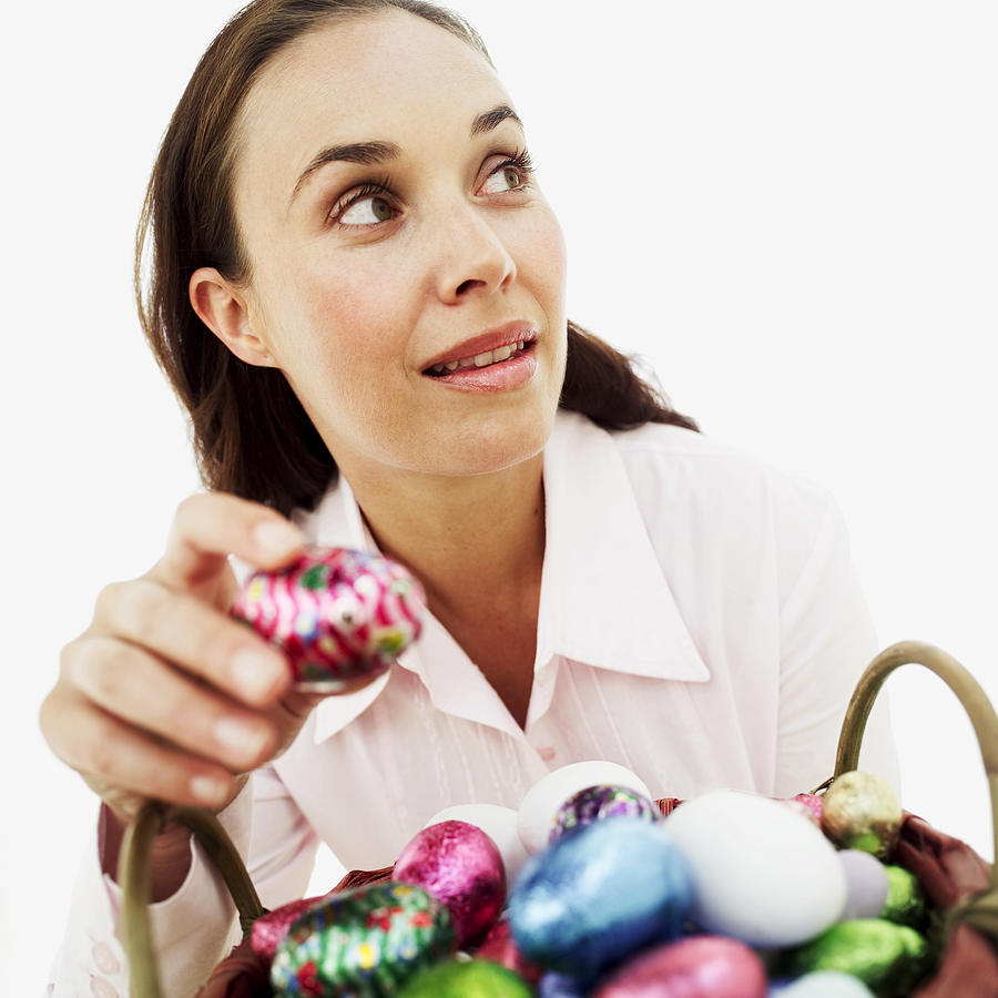 woman stealing an Easter egg Photograph by Stockbyte