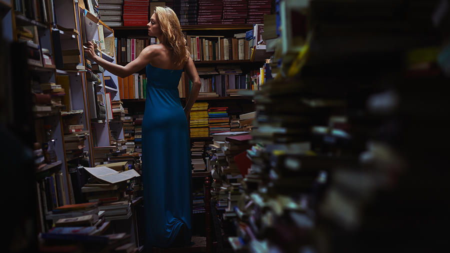 Woman surrounded by books Photograph by Roman Makhmutov