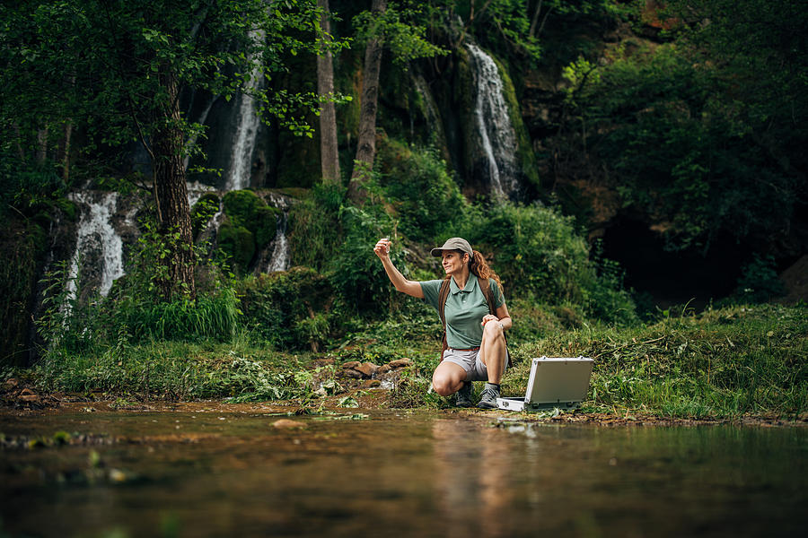 Woman Taking a Water Sample Photograph by South_agency