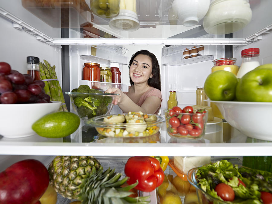 Woman Taking Broccoli From Fridge Photograph by Gerenme