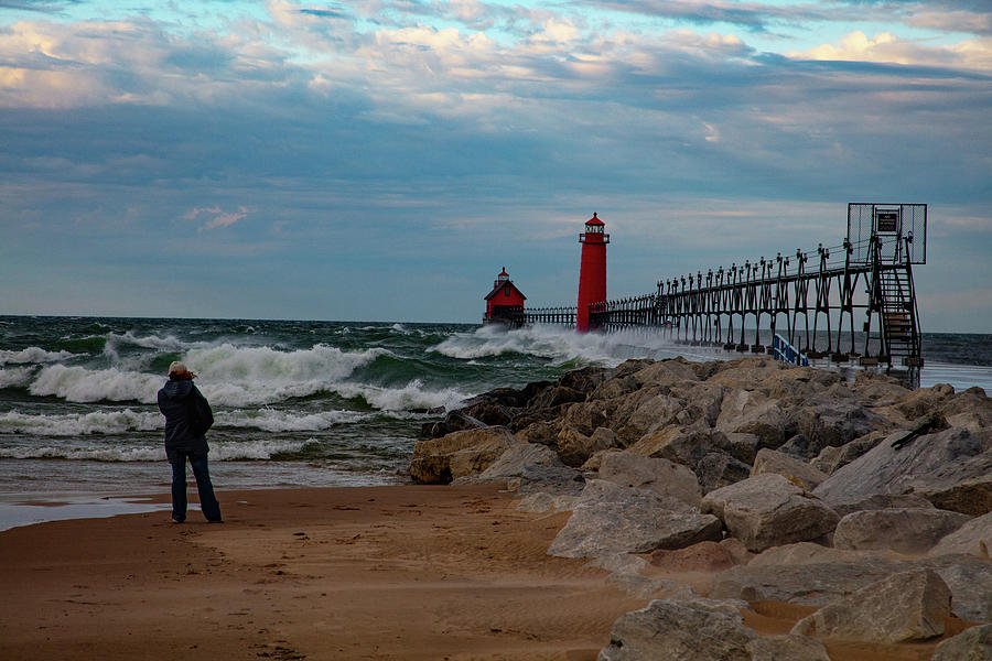 Woman taking photos of Grand Haven Michigan lighthouse Photograph by Eldon McGraw