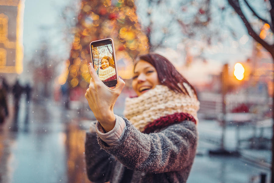 Woman taking selfie in front of the christmas tree Photograph by Alexandra Iakovleva