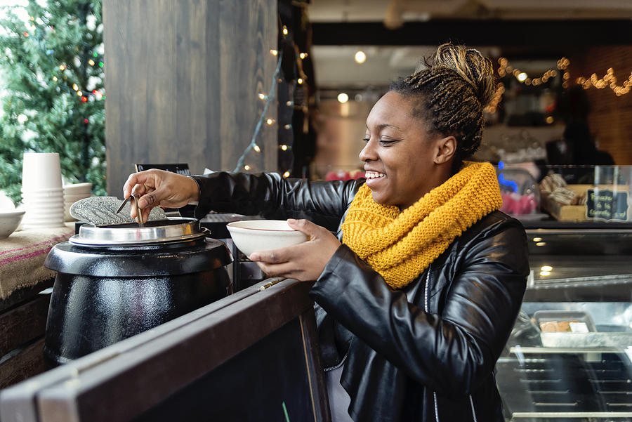 Woman taking soup in self service restaurant in winter. Photograph by Martinedoucet