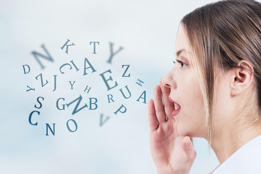 Woman talking with alphabet letters coming out of her mouth. Communication concept Photograph by SonerCdem