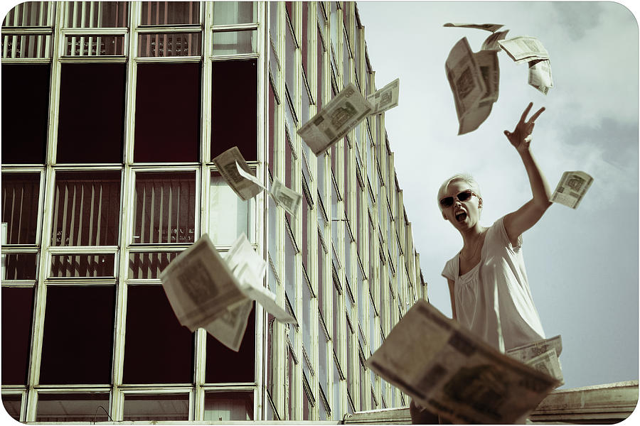 Woman throwing out money Photograph by Pawel Wewiorski