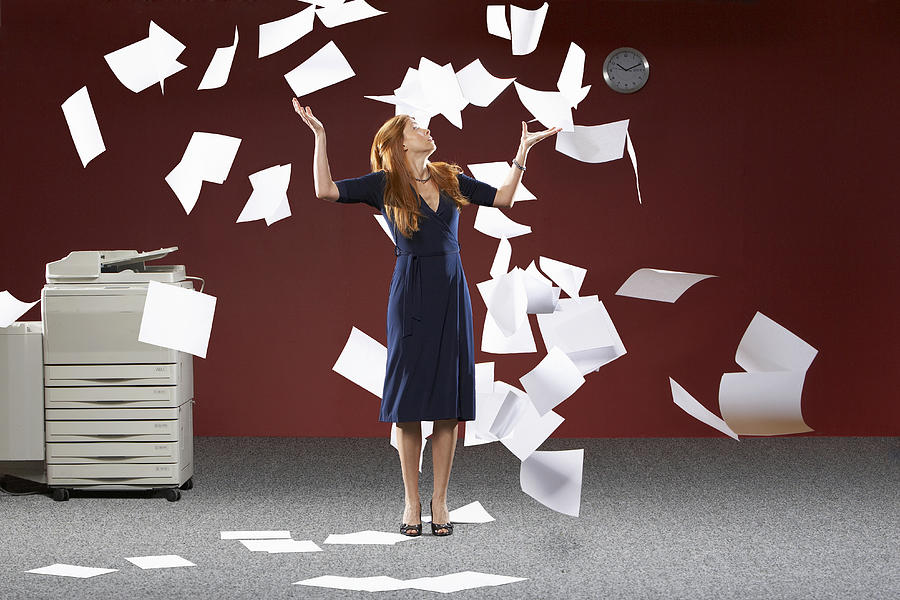 Woman throwing sheets of papers in air Photograph by Siri Stafford